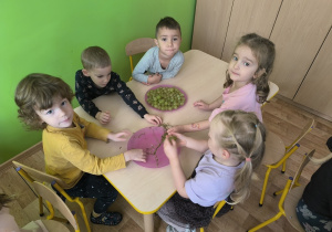 dzieci odrywają winogrono do miski