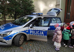dzieci ogladają samochód policyjny