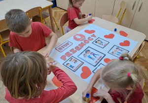 dzieci tworzą plakat "stop przemocy"
