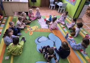 dzieci karmią smoka zdrowymi potrawami