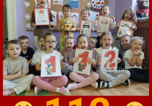 dzieci prezentują numery alarmowe