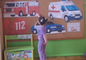 dziewczynka wskazuje wóz strażacki