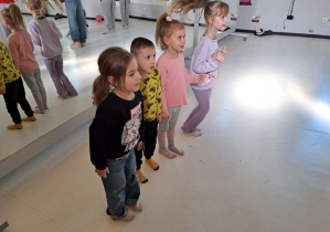 dzieci słuchają instrukcji jak wykonać ćwiczenie